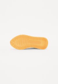 Semelle en caoutchouc avec une texture antidérapante, présentant un motif en zigzag et une forme arrondie à l'avant, dans une couleur orange vive.