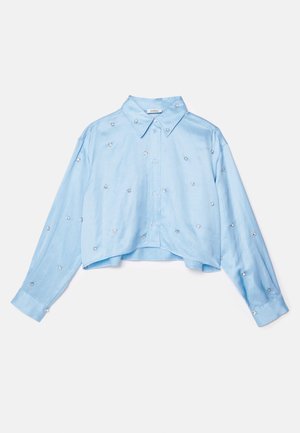 Light blue cropped shirt with long sleeves, button-up front, pointed collar, and scattered silver embellishments. Smooth fabric texture.