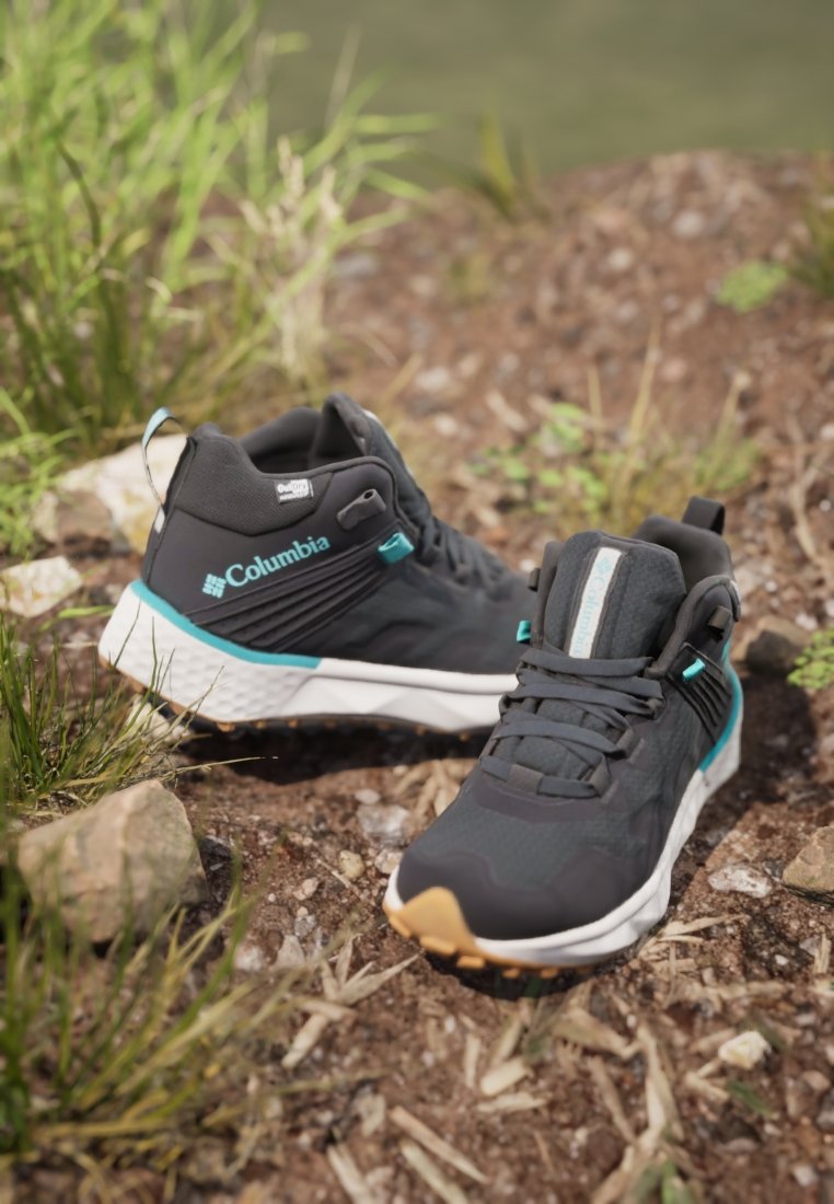 Czarno-niebieskie buty trekkingowe Columbia. Cholewka z siateczki i materiałów syntetycznych, wyściełana podeszwa, wysoka konstrukcja. Teksturowana powierzchnia, trwała podeszwa.