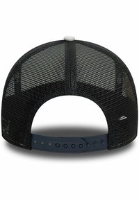 Gorra snapback de malla negra con visera negra sólida, correa ajustable de plástico y detalle de botón blanco en la parte superior. Malla texturizada para mayor transpirabilidad.