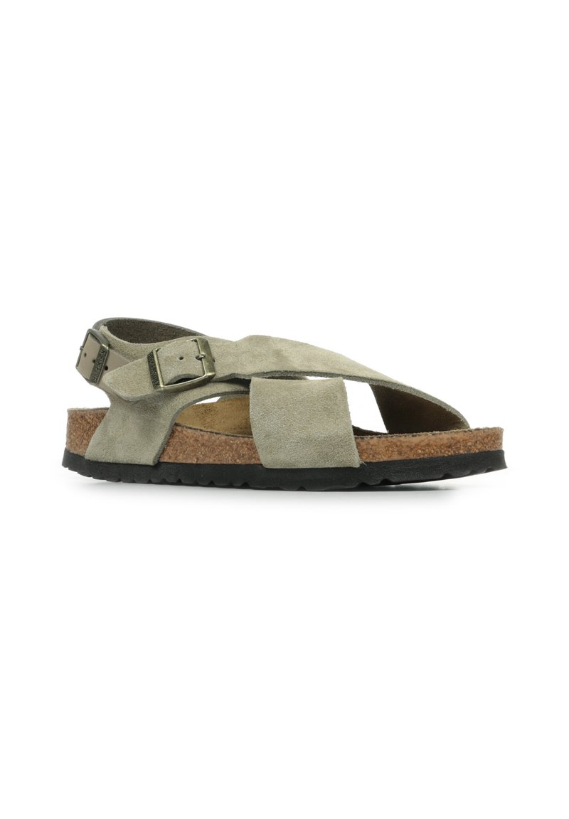 Green suede sandals with crisscross straps, adjustable metal buckles, a cork midsole, and a black rubber outsole.