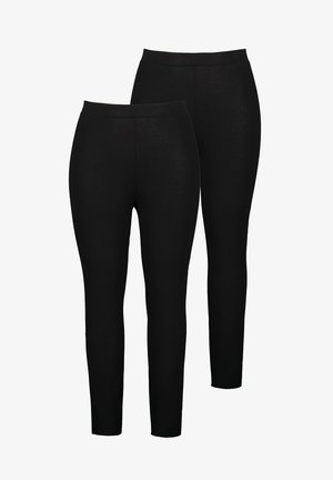 Musta trikoo, joka on valmistettu joustavasta kankaasta, jossa on sileä pinta ja korkea vyötärö. Kaksi paria esillä vierekkäin.