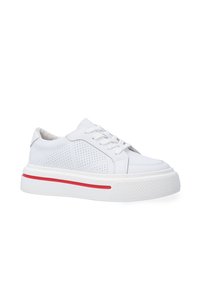 White sneaker with perforated side panels, flat laces, and a textured rubber sole. Features a red accent stripe along the midsole.