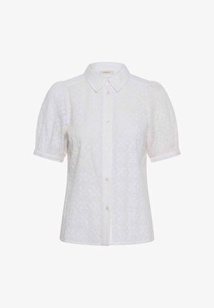 Blouse blanche texturée à manches courtes bouffantes, boutonnage sur le devant et col pointu classique.