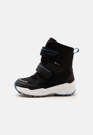 Schwarzer und blauer wasserdichter Winterstiefel mit zwei verstellbaren Riemen, weißer dicker Sohle und Zuglasche hinten, Seitenansicht.