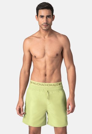 Lichtgroene zwemshorts met een elastische tailleband en merklogo. De shorts hebben een eenvoudig ontwerp en een gladde textuur.