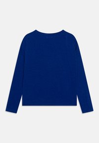 Long-sleeved top in deep blue fabric with a relaxed fit, featuring a rounded neckline and simple hemline without embellishments.