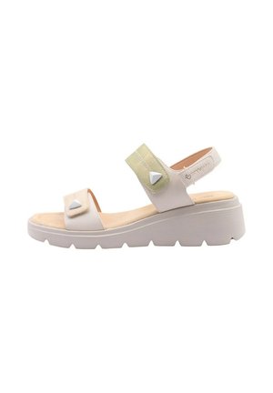 Sandalo beige con zeppa con due cinturini regolabili, bottoni bianchi triangolari e suola leggermente testurizzata per un uso casual.