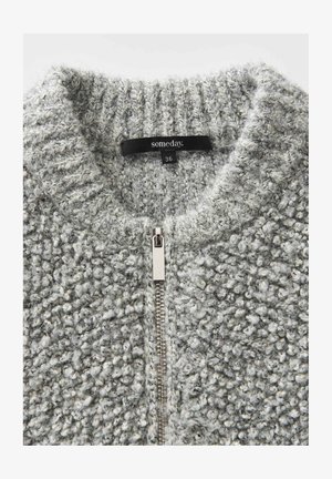 Gray zip-up cardigan made of textured fabric with a chunky weave. Features a high collar and silver zipper detail. Size tag reads "36."