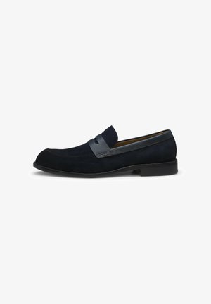 Men’s black suede slip-on loafer with smooth leather strap detail and low heel, shown in side profile on white background.