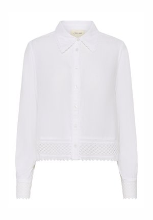 Bela majica z dolgimi rokavi in ovratnikom, gumbi spredaj, teksturirano blago ter čipkaste podrobnosti ob robu in manšetah.