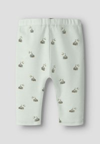 Witte geribde babylegging met een algeheel patroon van kleine circus tenten en halve manen in gedempte bruin- en beigetinten.