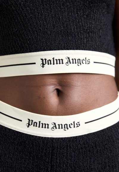 Black knitted crop top with a light-colored elastic band featuring the "Palm Angels" logo, outlined by a black stripe.