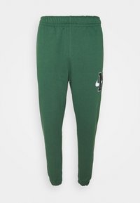 Gröna sweatpants med elastisk midja, muddade anklar och en tryckt logotyp på låret. Tillverkade av mjukt tyg med en slät yta.