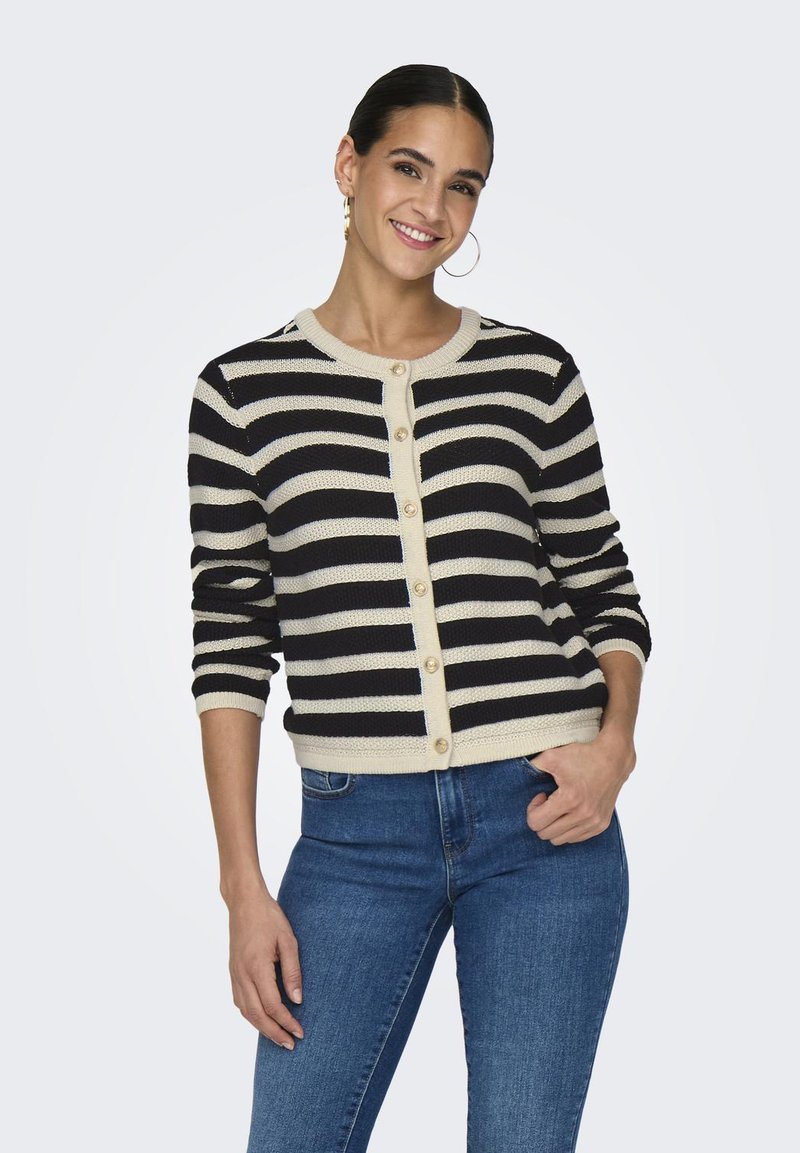 Black and cream striped cardigan with round neckline, button closure, and ribbed cuffs. Crafted from textured knit material.