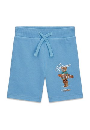 Hellblaue Kinder-Shorts mit Kordelzugbund und Grafik eines Bären, der auf dem rechten Bein ein Surfbrett mit der Aufschrift "Guess" hält.