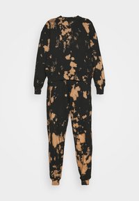 Sweat-shirt tie-dye noir et marron et pantalon de jogging assorti, manches longues, col rond et poignets élastiques.