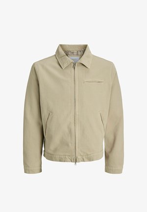 Veste décontractée beige à fermeture éclair avec col, deux poches latérales et une poche horizontale sur la poitrine, en tissu lisse.