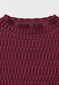 Burgundy ribbed sweater featuring a textured, woven pattern and a rounded neckline. Soft fabric with a subtle stretch and uneven hem.