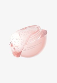 Masque lèvres au collagène PDRN dans un pot rose clair et arrondi, avec une texture lisse semblable à un gel et de petites bulles légères, équipé d'un couvercle légèrement surplombant.