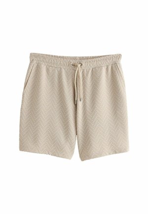 Pantaloni corti beige con motivo a spina di pesce, vita elastica con cordino, tasche laterali, realizzati in tessuto testurizzato.