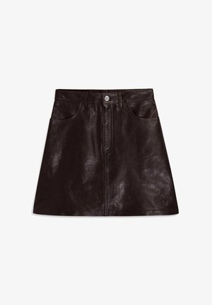 Brązowa skórzana spódnica o błyszczącej powierzchni, z dwoma przednimi kieszeniami, z zapięciem na zamek błyskawiczny i guzikiem. W kształcie litery A z teksturowaną powierzchnią.