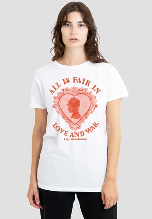 Junge Frau trägt ein weißes T-Shirt mit einem roten Herz und Silhouettenmotiv, auf dem Text steht "All is fair in love and war" und "Lady Whistledown".