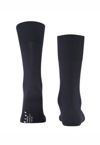 Smeđe crne čarape od mješavine pamuka s rebrastim rubom i glatkom teksturom. Imaju bijeli natpis marke tiskan blizu gležnja. Klasični dizajn do koljena.