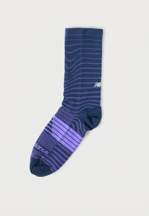 Námořnicky modrá a fialová sportovní ponožka s pruhovanými vzory a logem New Balance na kotníku a špičce.