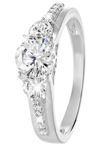 Bague en or blanc avec une grande pierre centrale en diamant rond, flanquée de petits diamants sur le bandeau et de accents pavés supplémentaires.