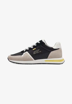 Black and gray fabric sneaker with beige suede accents, white midsole, yellow detailing, and traditional lacing system.
