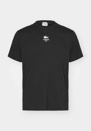 T-shirt noir à manches courtes et col rond avec petit logo blanc Lacoste et le texte "LACOSTE PARIS" centré sur la poitrine.