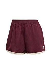 Pantalones cortos deportivos color marrón con una cinturilla elástica, detalles blancos a lo largo del dobladillo y un pequeño logo en la parte inferior izquierda. Textura de tela suave.