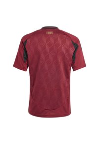Maillot bordeaux avec un motif géométrique, manches courtes, accents noirs et détail doré "1895" au niveau du cou. Finition en tissu texturé.