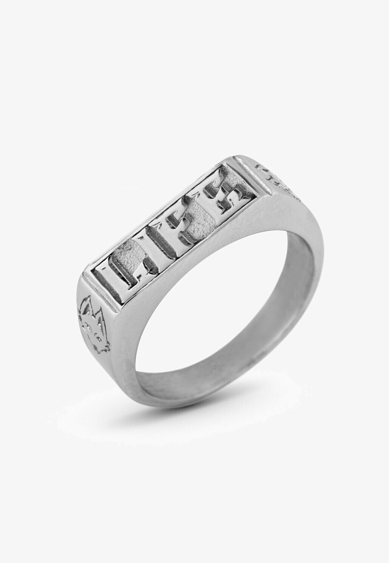 Silver metal ring featuring raised block letters spelling "LIFE", with a textured band and decorative accents resembling a wolf's face.