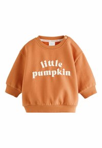 Orange toddler sweatshirt with ribbed cuffs and hem, featuring white text "little pumpkin" on the front and snap buttons on one shoulder.