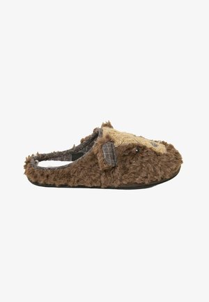 Brown plush slipper with a fuzzy texture, featuring a soft tan accent, open back, and gray plaid interior. Round toe and flexible sole.