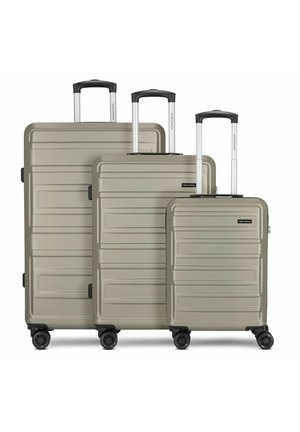 Three hard-shell suitcases in a muted olive color feature textured exteriors, retractable handles, and four wheels for mobility.