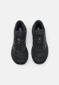 Black athletic shoes with a mesh upper, laces, and a cushioned sole. Features three stripe accents and a padded collar for comfort.