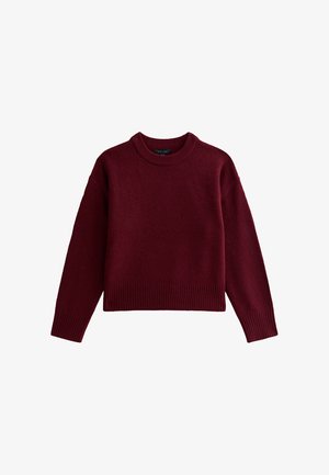 Bordeaux kleurige pullover trui, gemaakt van zachte gebreide stof. Kenmerkt lange mouwen, een ronde halslijn en ribbelboorden aan de onderkant en mouwen.