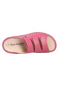 Pink leather sandal with cut-out design, beige insoles, stitched edges, and a smooth texture. Brand name "Finn Comfort" visible inside.