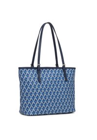 Sac fourre-tout bleu texturé avec un motif géométrique et des anses en cuir bleu marine, présentant une forme structurée et des finitions contrastantes.