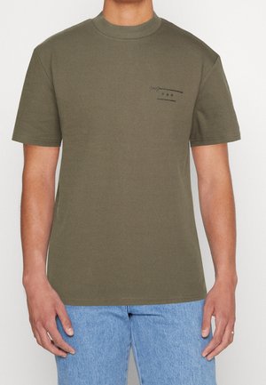 Olive green cotton t-shirt with a round neckline. Features short sleeves and a small logo print on the left chest. Soft texture.