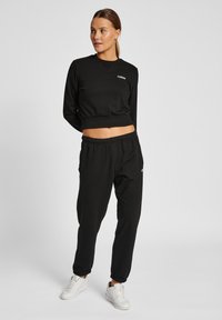 Hummel HMLLGC SHAI REGULAR  - Träningsbyxor - black