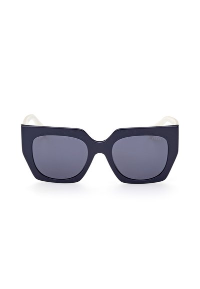 Black cat-eye sunglasses with matte finish, gray lenses, and contrasting white temples. Distinctive angular design, lightweight frame.