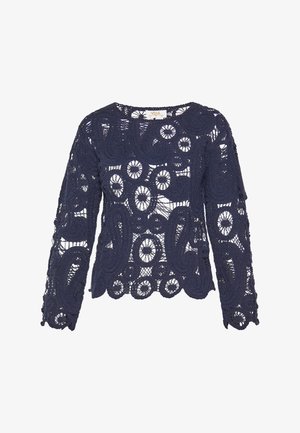 Top de encaje azul marino con mangas largas, que presenta intrincados patrones circulares y en espiral, un dobladillo de ondas y un escote redondo.