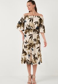 Off-the-shoulder midi dress with a beige base, featuring dark green and blue leaf patterns, a fitted waist, and flutter sleeves.