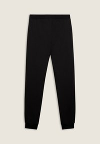 Pantalones jogger negros ajustados con cintura elástica y tobilleras acampanadas, colocados sobre un fondo neutro.