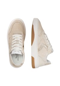 Beige sneakers with a textured mesh design, suede accents, white laces, and a gum sole. Features discreet branding on the tongue.