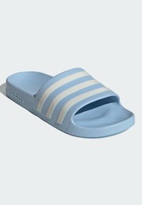 Light blue slide sandal with three white striped accents, made of textured synthetic material, featuring an open toe and a flat sole.